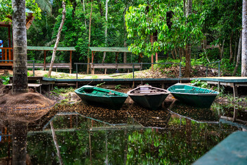 Three wooden boats in the jungle in Peru