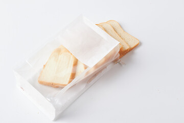 Slices of White Bread Packaged and Ready for Use on a Clean White Surface