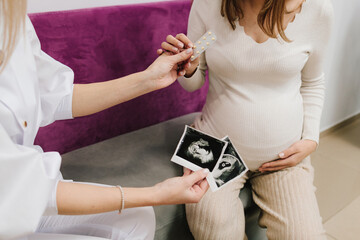 Gynecologist prescribes prenatal vitamins and nutritional supplement to pregnant woman. Gynecology...