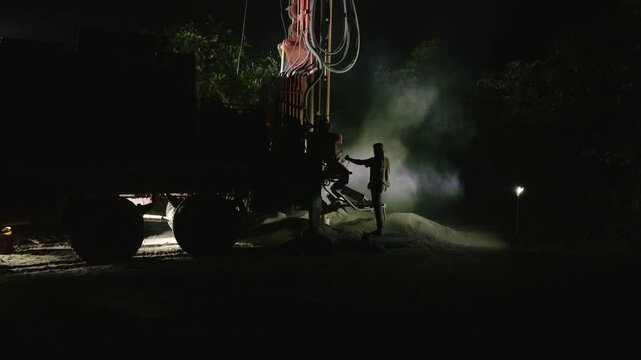 Borewell drilling digs deep into dry earth at night