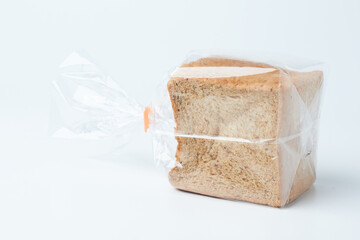Freshly Packaged Whole Grain Bread Loaf Sitting on a Plain Surface Near a Bakery