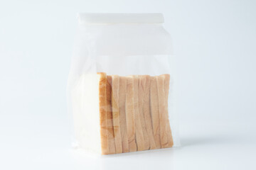 Sliced Bread Packed in a Transparent Bag Arranged Neatly on a White Background