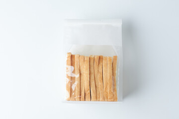 Handmade Caramel Sticks in a Clear Packaging on a White Background, Ideal for Treats and Gifts