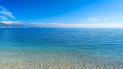 Obraz premium Blue Ocean Waters Under A Clear Sky With Glistening Reflections During Daytime