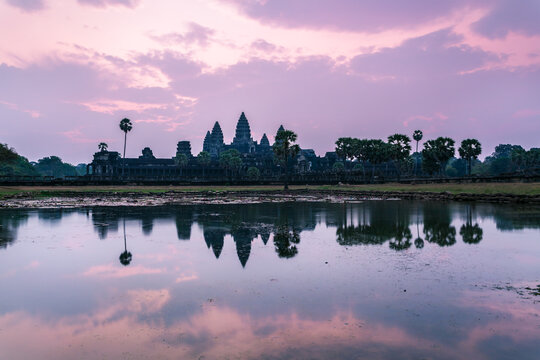 Angkor Wat temple at sunrise reflected into water, Cambodia
