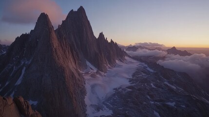 Fototapeta premium stunning mountain landscape photography Stunning mountain peaks bathed in soft sunset light above a glacier and clouds.