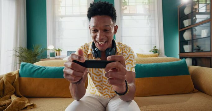 Gaming, controller and winner with man on sofa for celebration, streaming and esports subscription. Success, competition and virtual with person in living room at home for contest, pov or video games