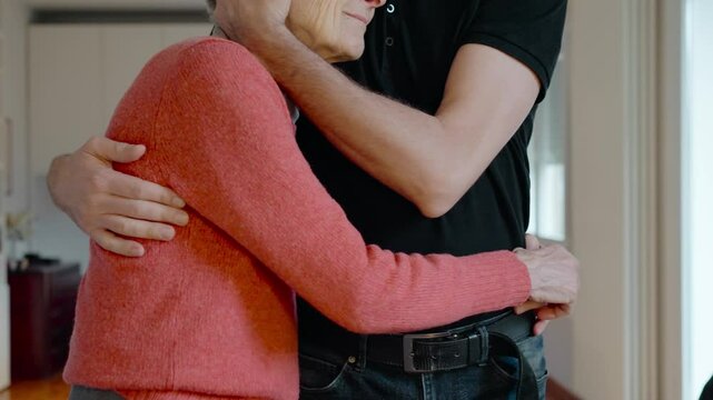 Elderly care. Caregiver son assisting elderly mother with cognitive decline. Neurodegenerative disease and mental health concept. Son taking care of old mother. 