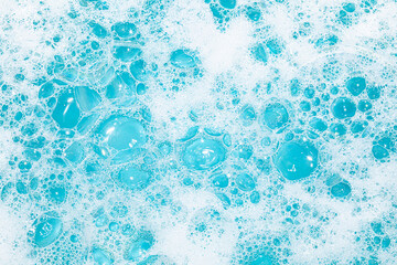 Bright bubbles create a vibrant texture in blue water with a foamy appearance.