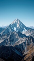 Majestic snow-capped mountain peak under clear blue sky