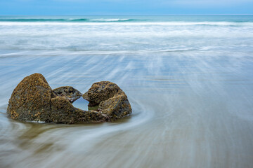 Long exposure shot of Moeraki Boulders in New Zealand. Famous landmark large spherical stones on Koekohe Beach near Moeraki on New Zealand's Otago coast. A popular tourist attraction