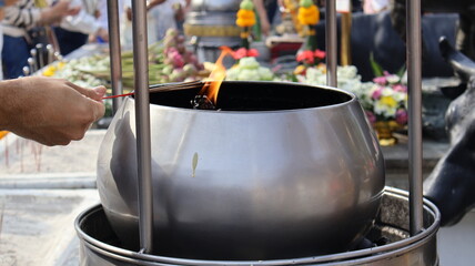 A pot for holding fuel for burning incense sticks and candles to worship sacred objects of...