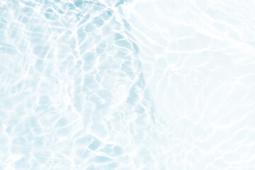 Blue water with ripples on the surface. Defocus blurred transparent blue colored clear calm water surface texture with splashes and bubbles. Water waves with shining pattern texture background.