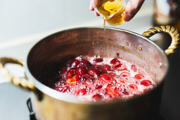 pouring whiskey into jam,homemade healthy jam,home recipe