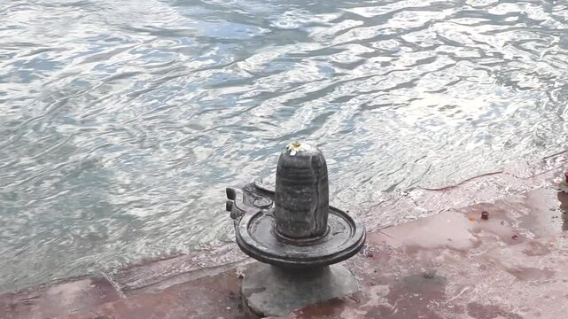 The Lord Shiva lingam stone on bank of river Ganga for worship.