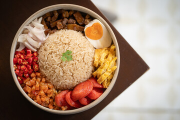 Delicious rice bowl with various toppings including vegetables, meat, and egg, showcasing vibrant colors and textures. Perfect for hearty meal