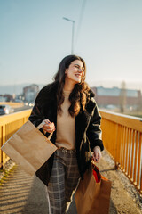 Young caucasian woman go home with full shopping bags after shopping	
