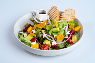 Fresh salad with mixed greens, colorful vegetables, and dressing