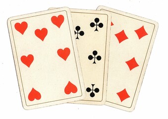 Antique playing cards showing three of the same value on a white background.