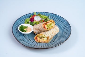 Delicious wrap filled with fresh vegetables and served with side salad and dipping sauce, perfect...