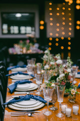 Elegant dining setup with floral decorations and soft lighting for a special occasion in an intimate venue