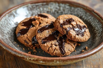freshly baked chocolate chip cookies arranged on rustic ceramic plate warm lighting crumbs and melted chocolate details