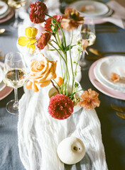 Elegant floral centerpiece graces a beautifully set dining table for a special occasion