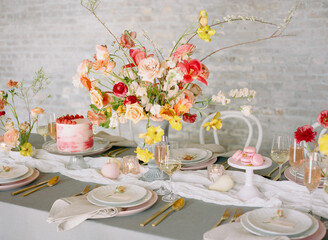 Elegant floral centerpiece enhances a beautifully arranged dessert table for a spring celebration