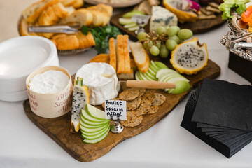 Delicious cheese and fruit platter displayed at a catered event in a charming venue during daylight hours