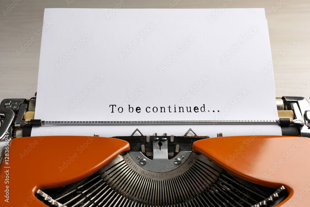 Fototapete typewriter with sheet of paper, closeup. typed text to be continued