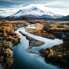 Tranquil River Flowing Towards Majestic Snow-Covered Peak Aerial View