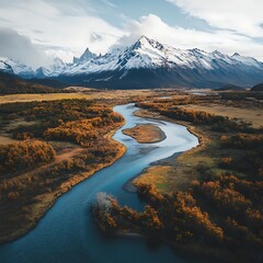 Tranquil River Flowing Towards Majestic Snow-Covered Peak Aerial View