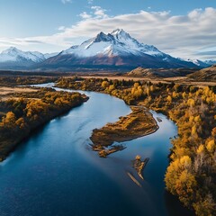 Tranquil River Flowing Towards Majestic Snow-Covered Peak Aerial View