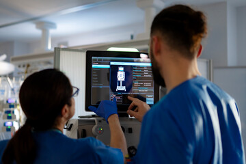 icu nurses operating a dialysis machine in intensive care