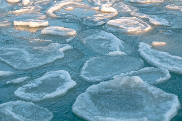 Ice-covered sea cliffs. The beauty of the winter sea.