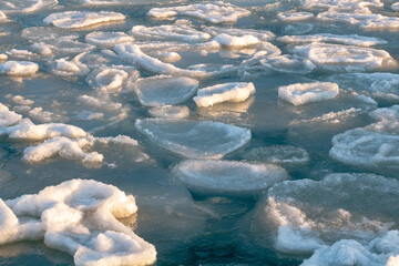 Ice-covered sea cliffs. The beauty of the winter sea.