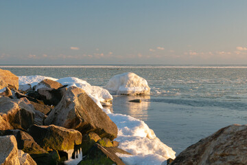 Ice-covered sea cliffs. The beauty of the winter sea.