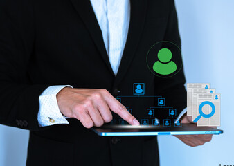 Business man work with laptop seek data to find a new job icon are floating on screen of tablet.