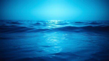 Gentle ocean waves create a calming scene, the sea reflecting the blue sky in a beautiful vista.