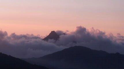Obraz premium Mountain peaks rise above a blanket of fog under a soft, pastel sky at sunrise.