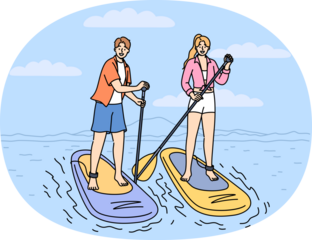 Surfing on SUP boards is practiced by man and woman using paddles to navigate river on summer weekend. Man and woman surfers stand on SUP boards, engage in active recreation at hot resort