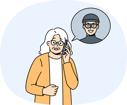 Elderly woman talking to telephone scammer who is trying to find out bank account password. Telephone scammer calls grandma, intimidating and forcing to provide personal information or using blackmail