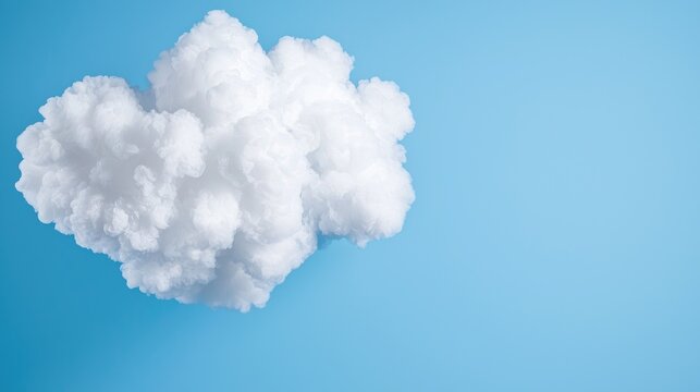Fluffy cloud against a vibrant blue background.  Possible use Stock photo for inspirational or nature-related design projects