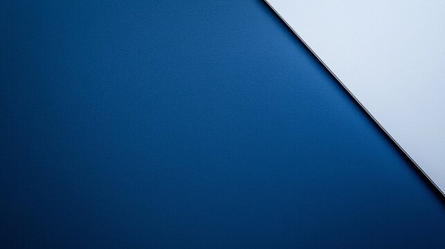 Close up of a laptop with a mouse on a minimalist navy blue and white background
