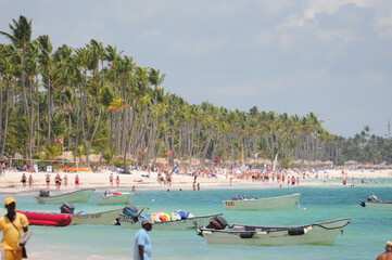 Punta Cana, La Altagracia, Domenican Republic. May 09, 2012: Crowded Punta Cana beach lined with...