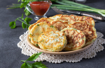 Fried fritters with green onion and cheese served for breakfast with ketchup