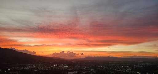 Fiery sky over city at dusk.