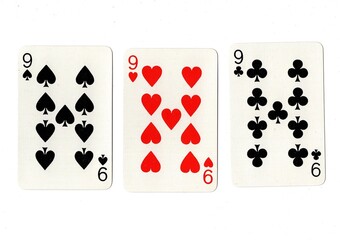 Playing cards showing three of the same value on a white background.