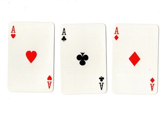 Playing cards showing three of the same value on a white background.