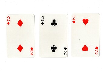 Playing cards showing three of the same value on a white background.